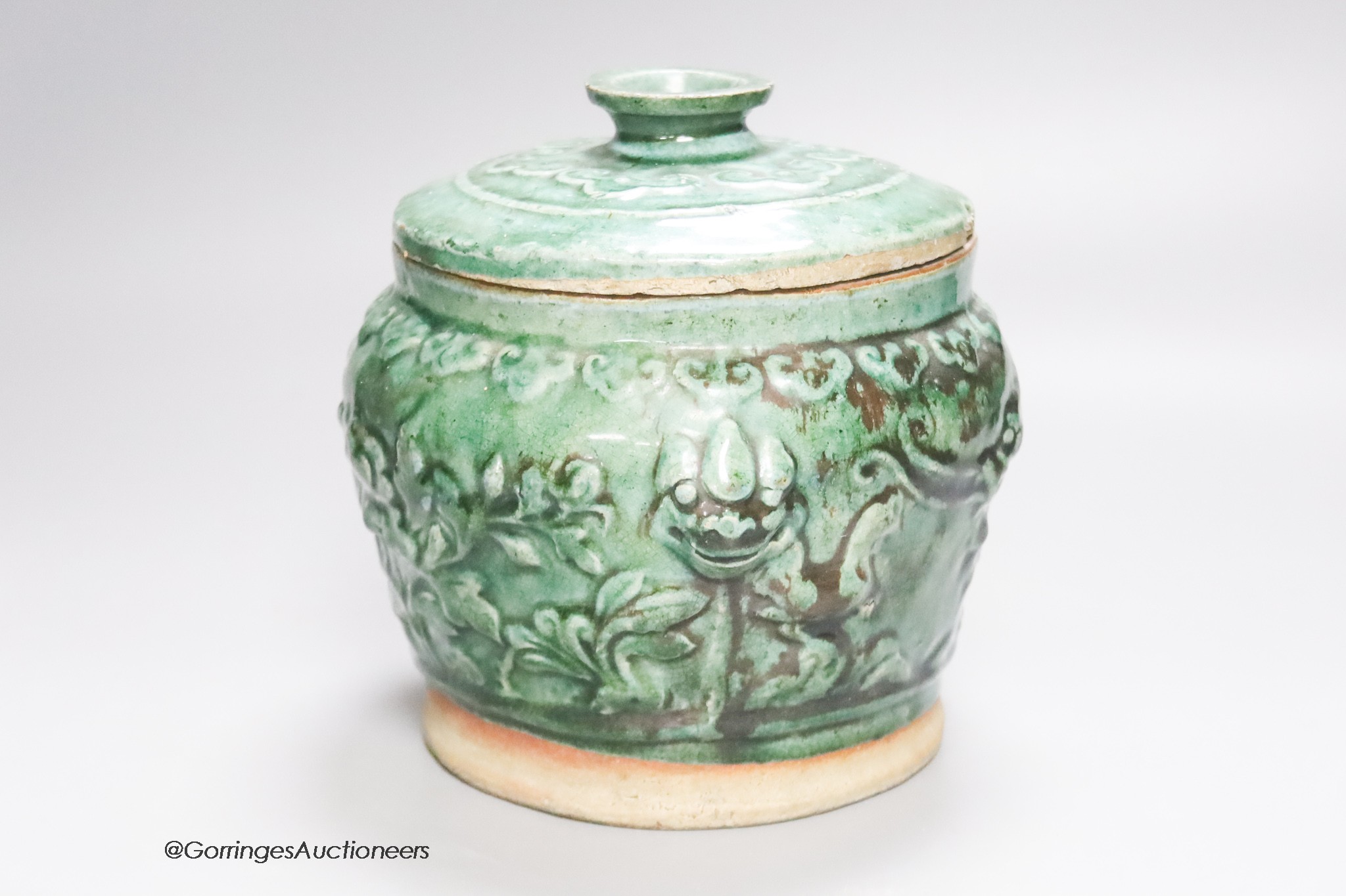 A 19th century Chinese green glazed jar and cover, height 19cm